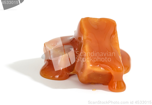 Image of caramel candies on white background