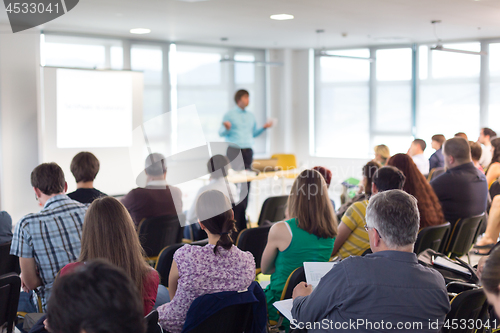 Image of Speaker giving presentation on business conference.