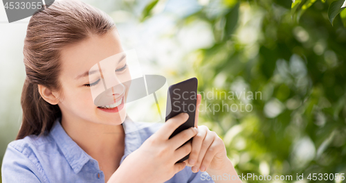 Image of happy girl with smartphone over natural background