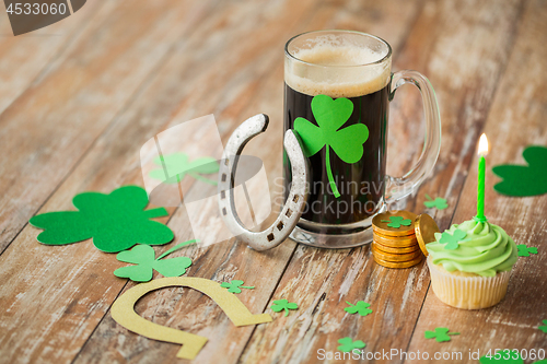 Image of glass of beer, horseshoe, green cupcake and coins