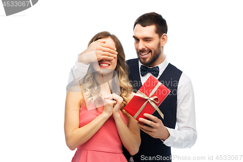 Image of happy man giving woman surprise present