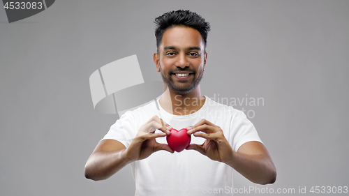 Image of indian man with red heart over grey background