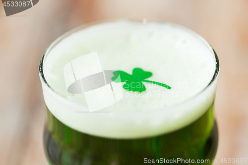 Image of close up of glass of green beer with shamrock