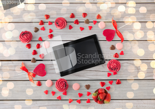 Image of tablet pc and sweets on valentines day