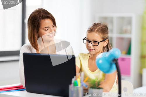 Image of mother and daughter with laptop doing homework