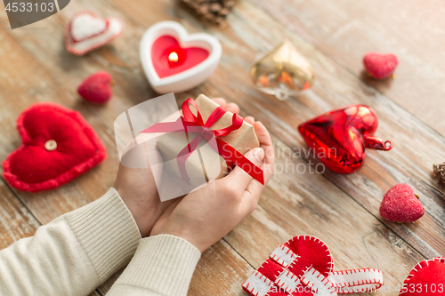 Image of close up of hands holding christmas gift