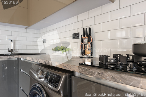 Image of Closeup of luxury modern white, beige and grey kitchen interior