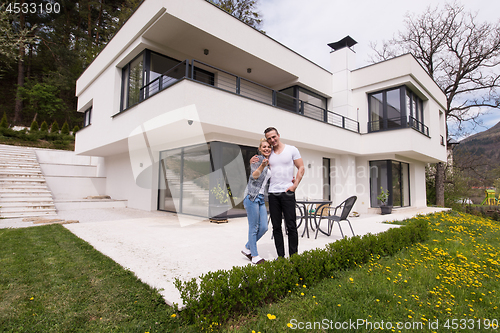 Image of couple hugging in front of  new luxury home