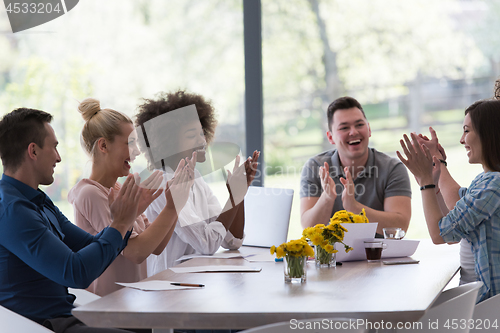 Image of multiethnic startup Group of young business people celebrating s