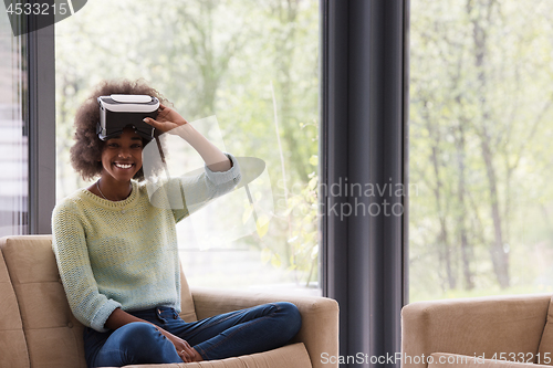 Image of black woman using VR headset glasses of virtual reality