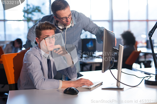 Image of Two Business People Working With computer in office