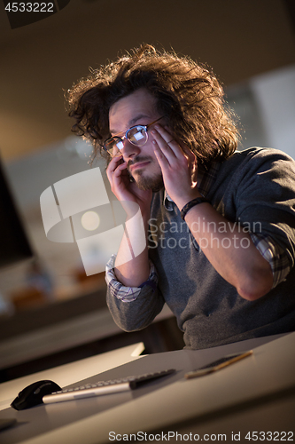 Image of businessman relaxing at the desk