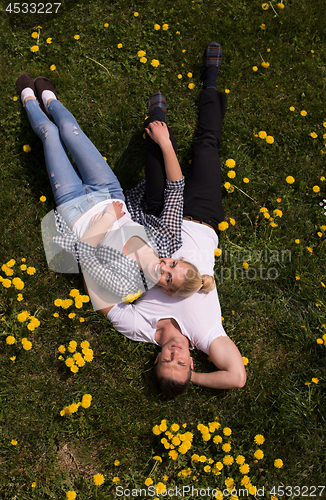 Image of man and woman lying on the grass