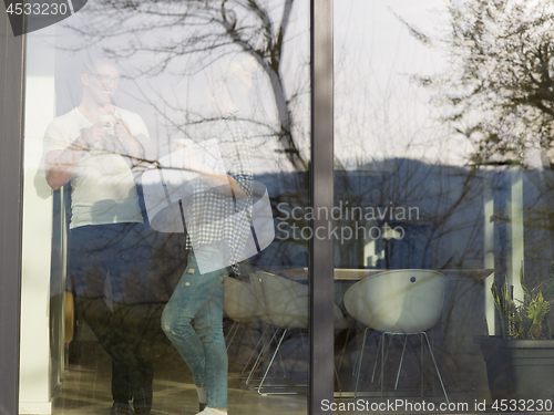 Image of young couple enjoying morning coffee