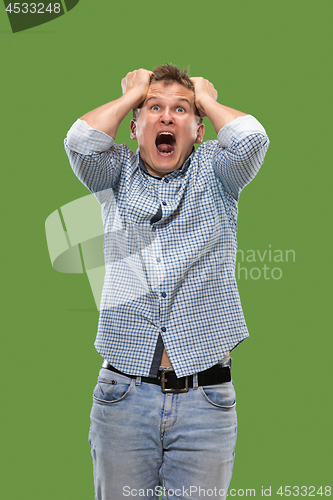 Image of Portrait of the scared man on green
