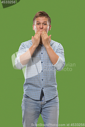 Image of Portrait of attractive man with kiss isolated over green background
