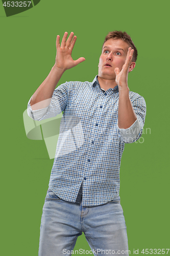 Image of Portrait of the scared man on green