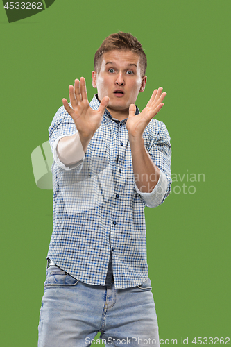 Image of Portrait of the scared man on green