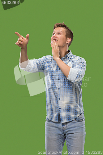 Image of Isolated on green young casual man shouting at studio