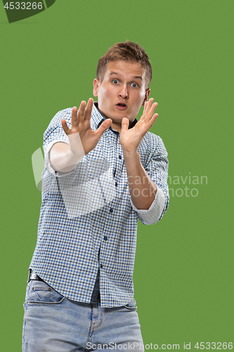 Image of Portrait of the scared man on green