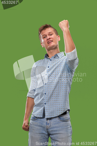 Image of Winning success man happy ecstatic celebrating being a winner. Dynamic energetic image of male model