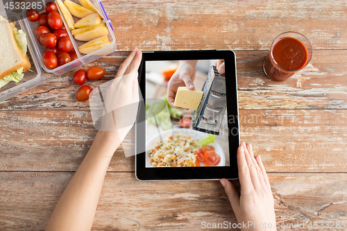 Image of woman watching cooking video on tablet computer