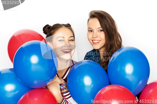 Image of happy teenage girls with helium balloons