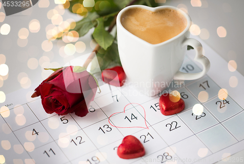 Image of close up of calendar, hearts, coffee and red rose