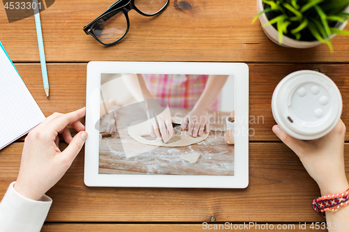 Image of woman watching cooking video on tablet computer