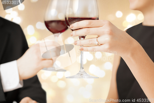 Image of close up of couple clinking champagne glasses