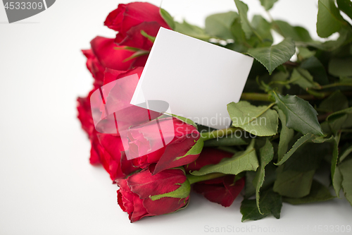 Image of close up of red roses and letter or note