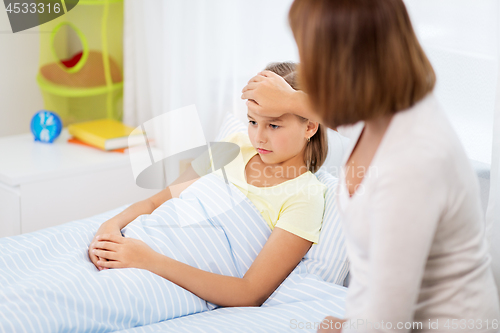 Image of mother taking care of unhealthy daughter at home