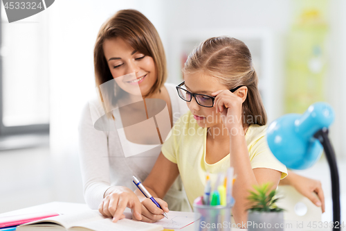 Image of mother and daughter doing homework together