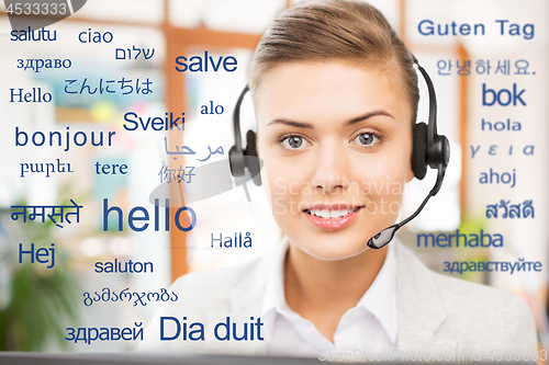 Image of woman in headset over words in foreign languages