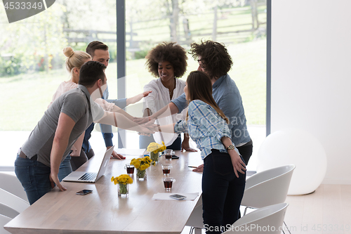 Image of multiethnic startup Group of young business people celebrating s