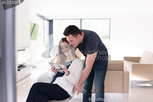 Image of couple using tablet at home