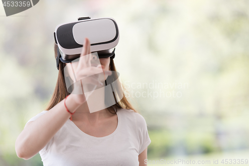 Image of woman using VR-headset glasses of virtual reality