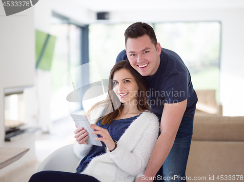 Image of couple using tablet at home