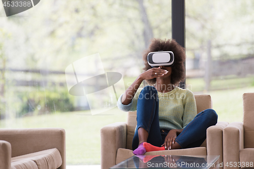 Image of black woman using VR headset glasses of virtual reality