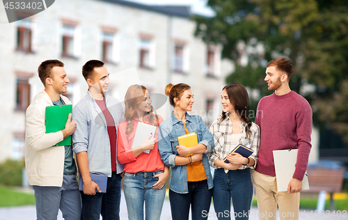 Image of group of smiling students talking over campus