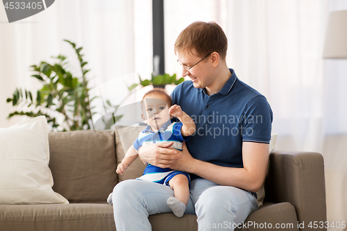 Image of happy father with baby son at home