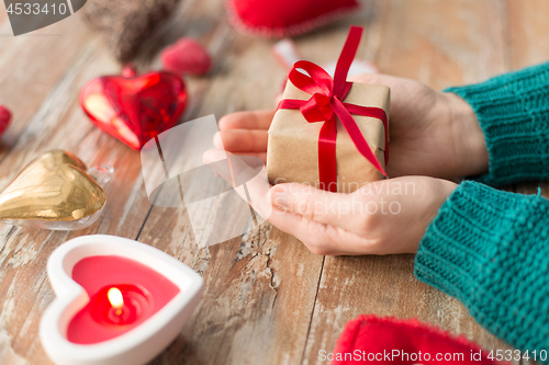 Image of close up of hands holding christmas gift