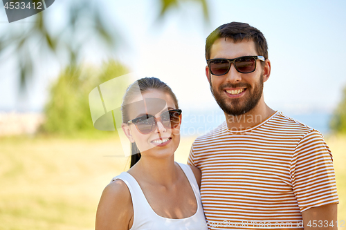 Image of happy couple in sunglasses outdoors in summer