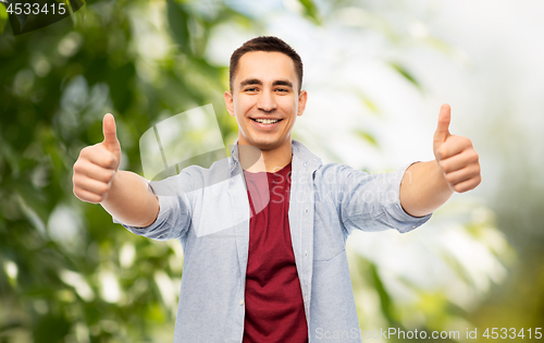 Image of happy young man showing thumbs up