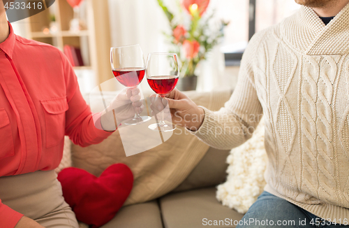 Image of happy couple drinking red wine on valentines day