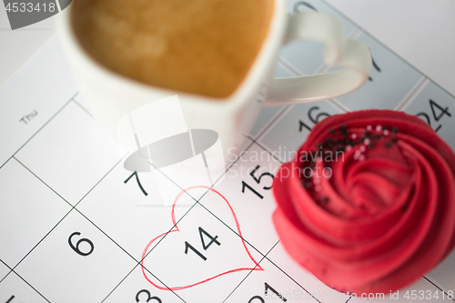 Image of close up of calendar, coffee, cupcake and heart