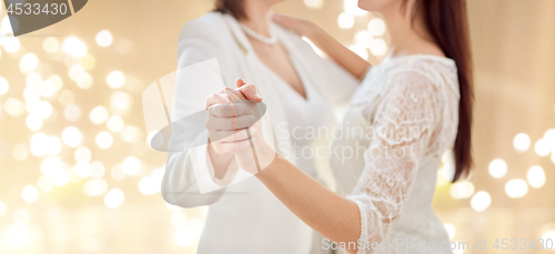 Image of close up of happy married lesbian couple dancing