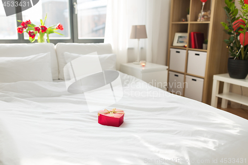 Image of heart shaped gift box on bed at home bedroom 