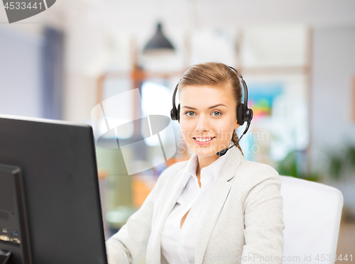 Image of helpline operator in headset working at office