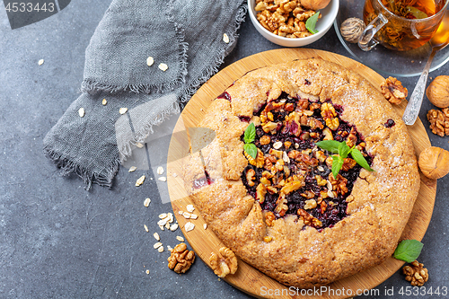 Image of Galette pie with oat flakes, currant and walnuts.